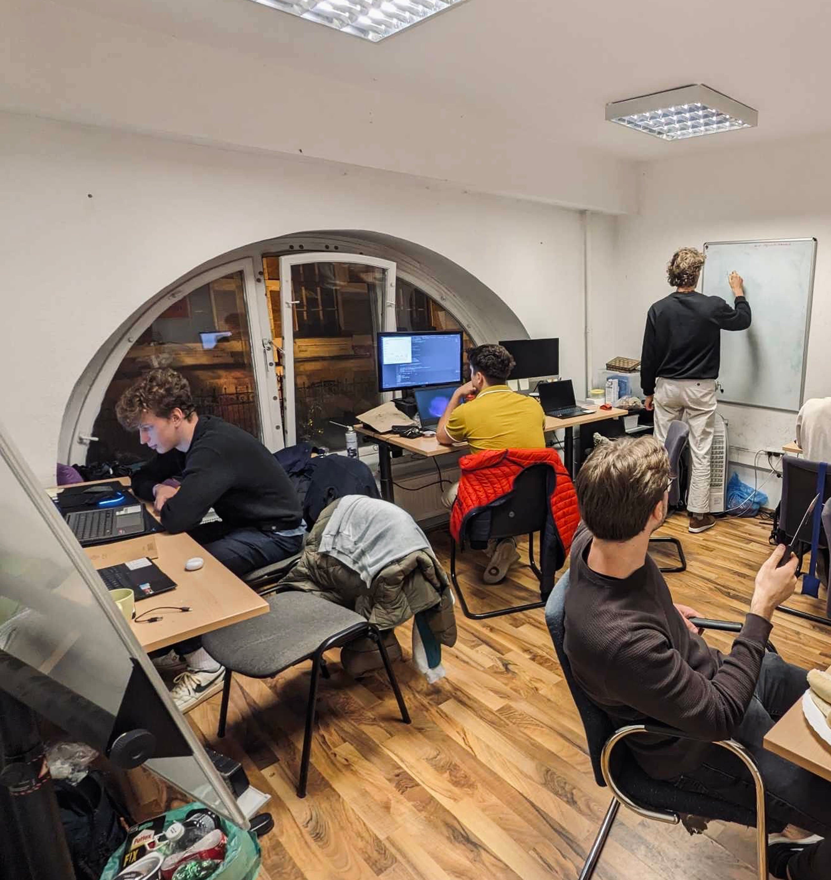 mesh. hackerspace with people working on computers